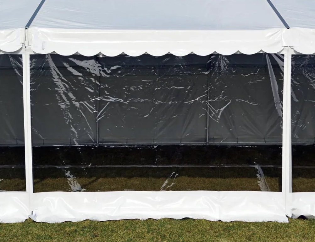 Eight shirts arranged on table in black, olive, grey, blue, white, red, mustard, and green.