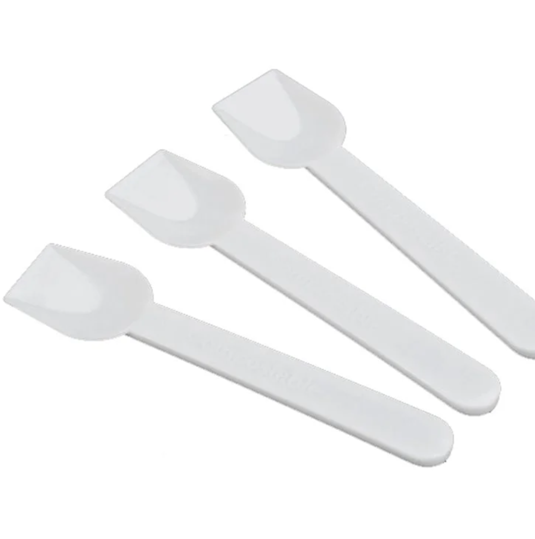 Eight shirts arranged on table in black, olive, grey, blue, white, red, mustard, and green.