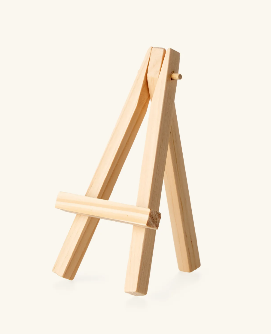 Eight shirts arranged on table in black, olive, grey, blue, white, red, mustard, and green.