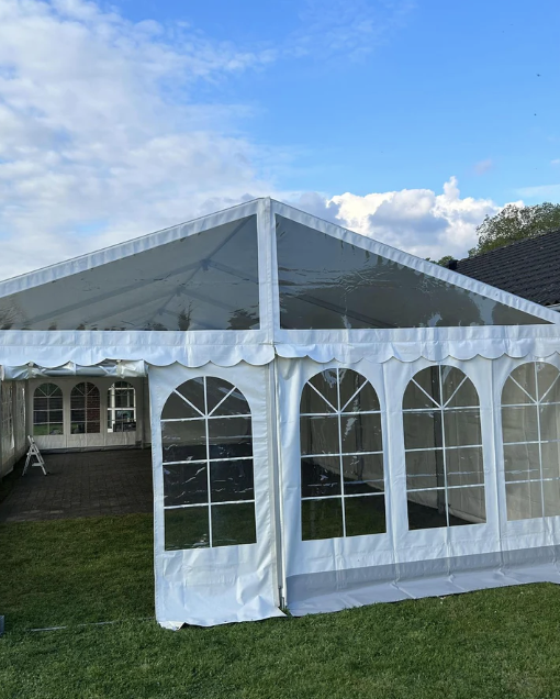 Eight shirts arranged on table in black, olive, grey, blue, white, red, mustard, and green.