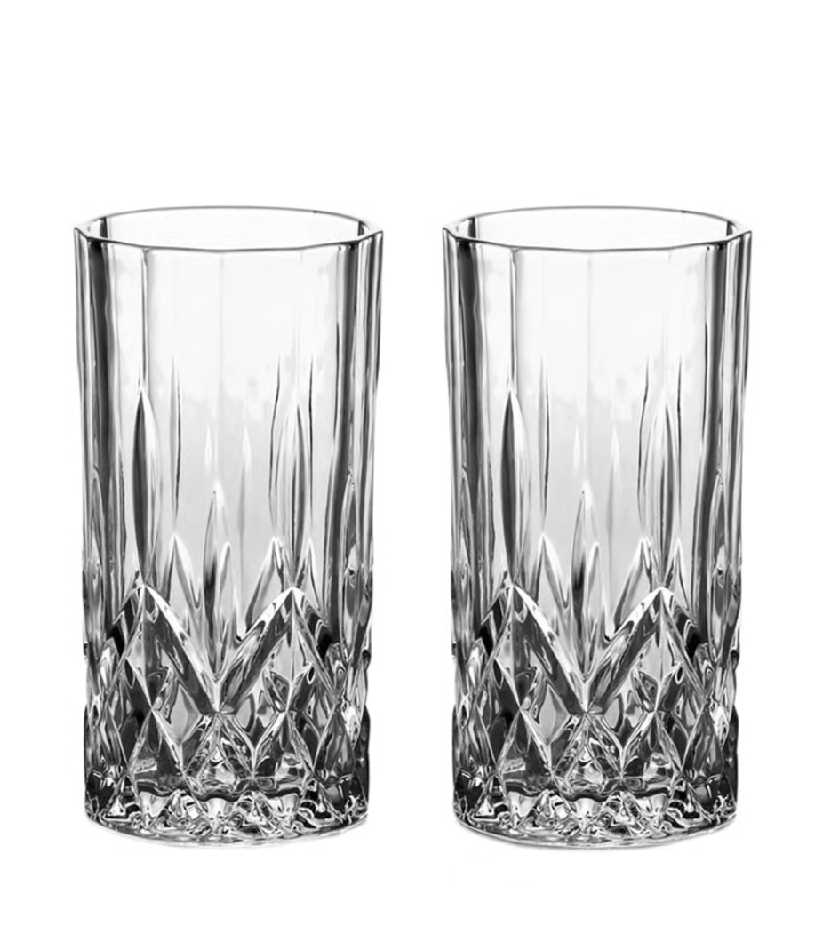 Eight shirts arranged on table in black, olive, grey, blue, white, red, mustard, and green.