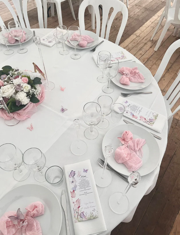 Eight shirts arranged on table in black, olive, grey, blue, white, red, mustard, and green.