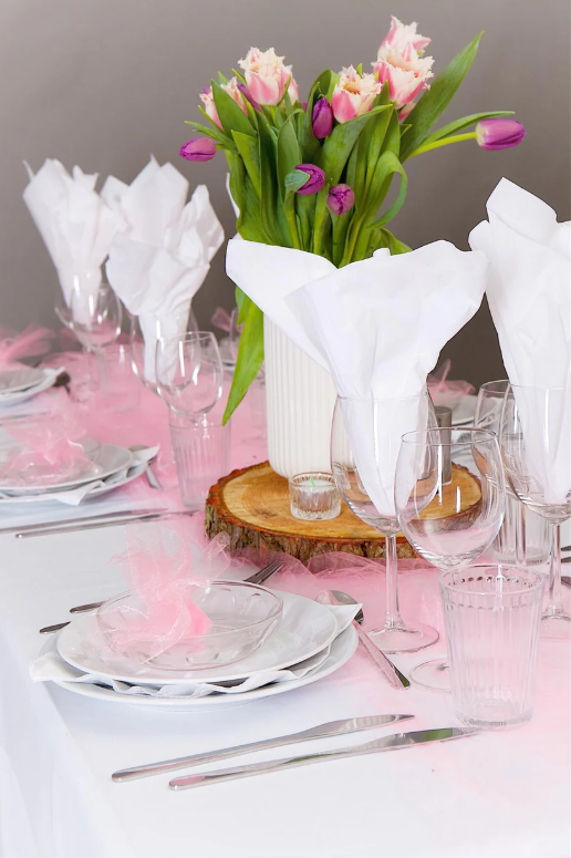 Eight shirts arranged on table in black, olive, grey, blue, white, red, mustard, and green.