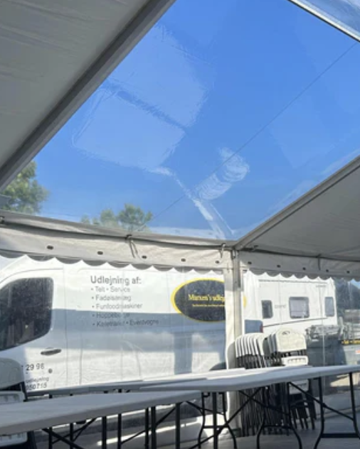 Eight shirts arranged on table in black, olive, grey, blue, white, red, mustard, and green.