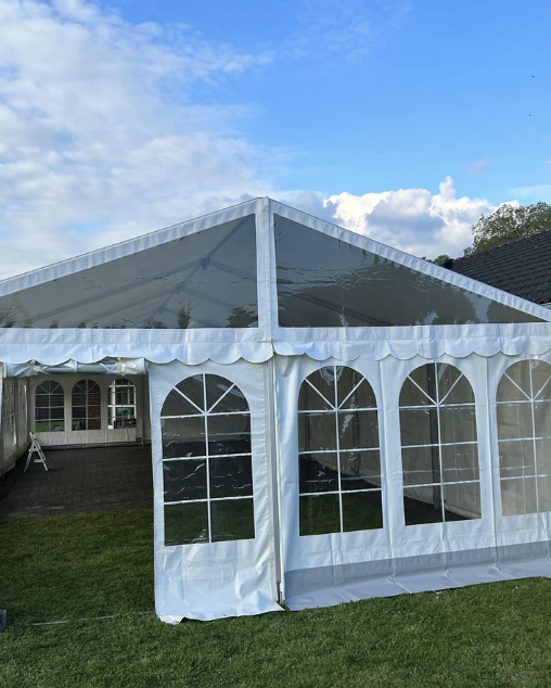 Eight shirts arranged on table in black, olive, grey, blue, white, red, mustard, and green.